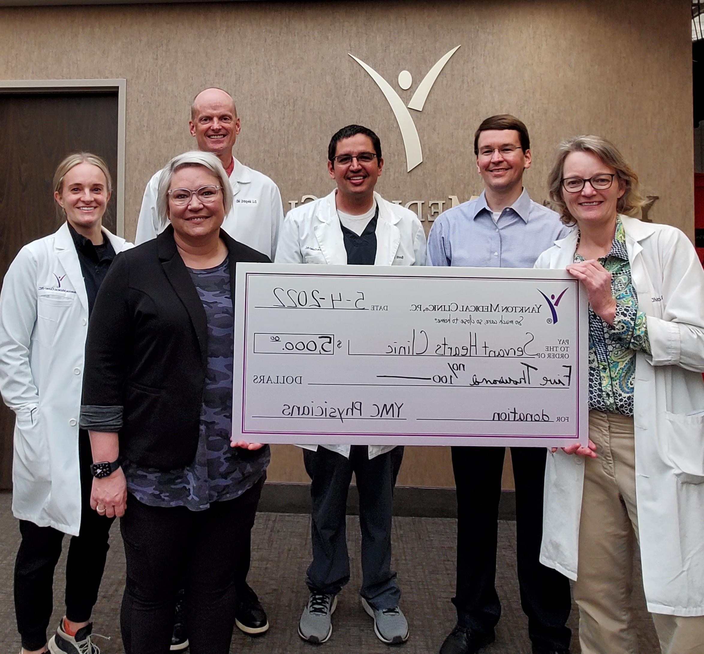 YMC Makes Donation to Servant Hearts Clinic